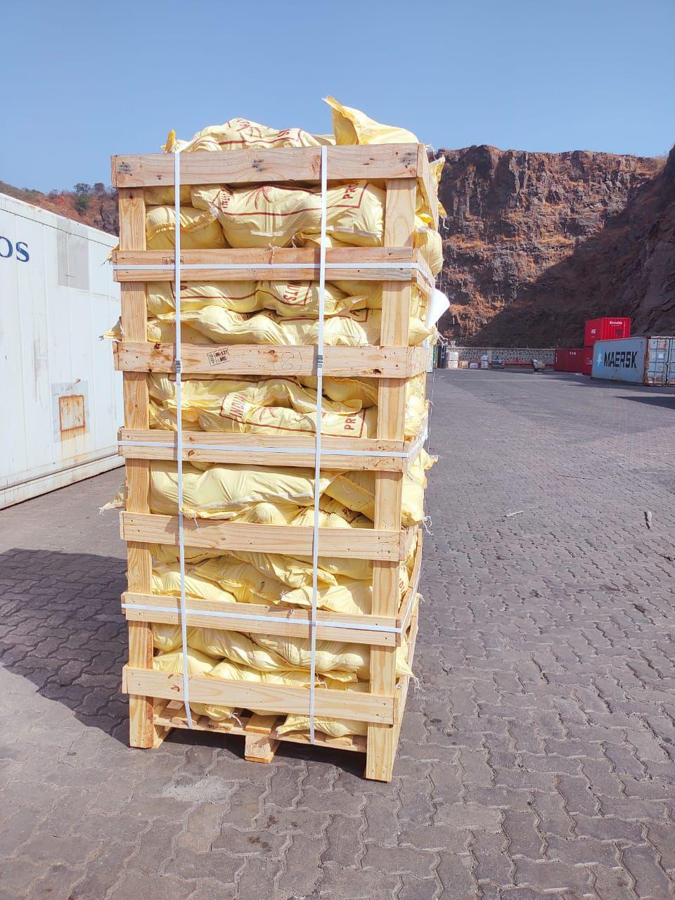 Export-ready coconut crates with yellow wrapping prepared for international shipping